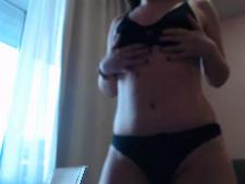 This webcam lady demonstrates her cup size A breast part behind the webcam